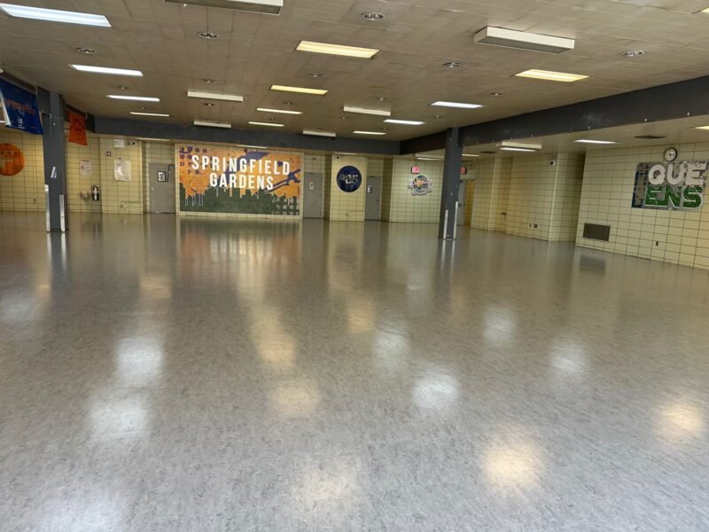 Empty cafeteria with polished floor and wall mural