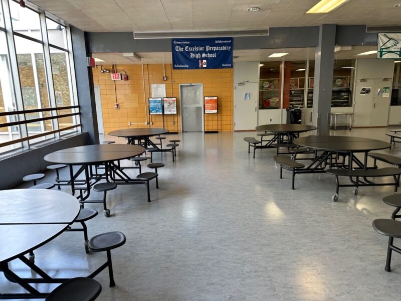 Renovated cafeteria with round tables and large windows