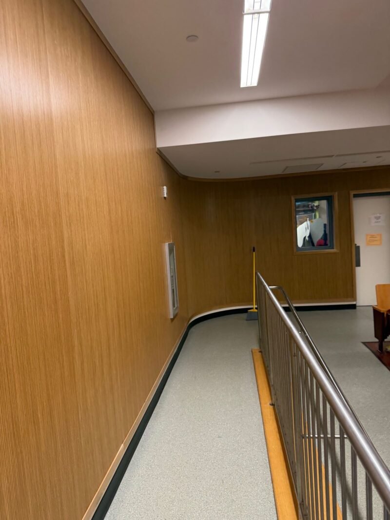 Corridor with wood paneling, stair railing and new flooring