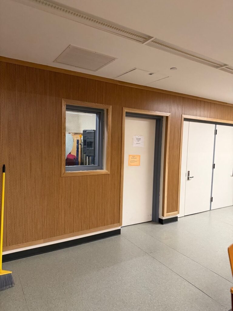 Wood paneling around doors and a vision panel