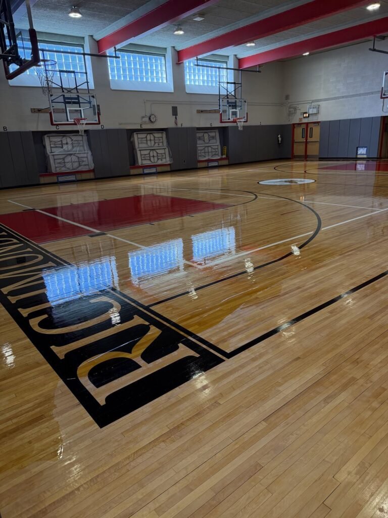 Refinished gymnasium court with red keys and glass block windows