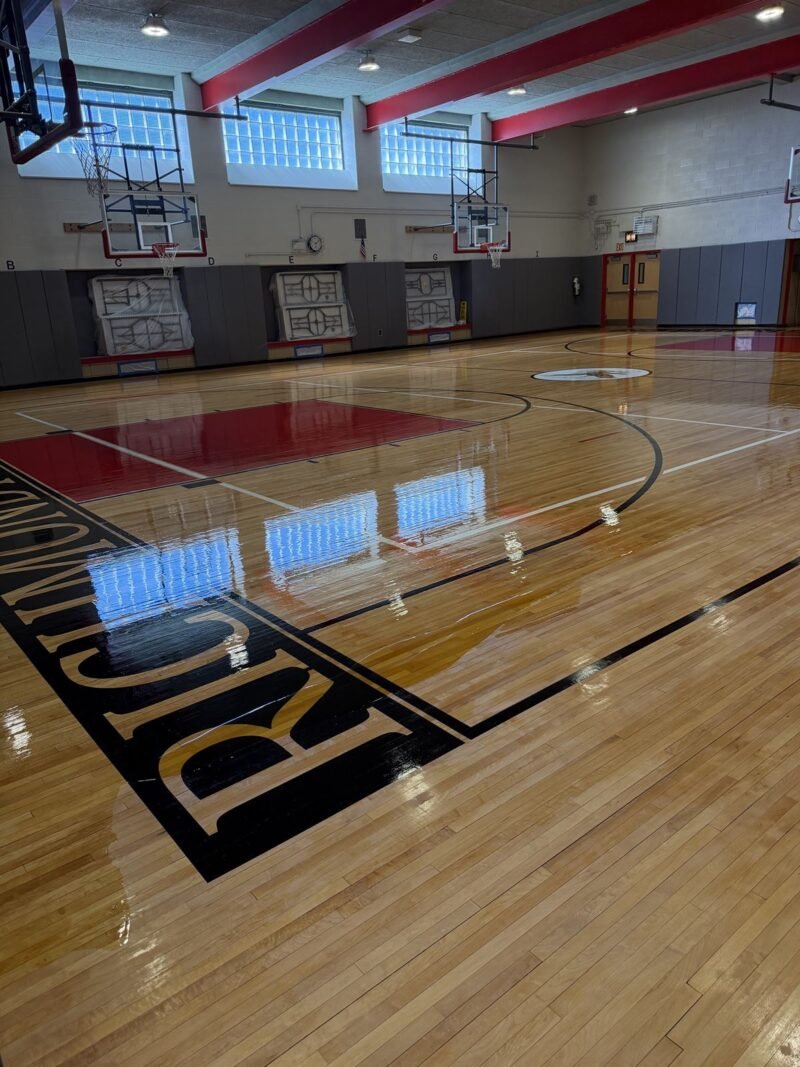 Refinished gymnasium court with red keys and glass block windows